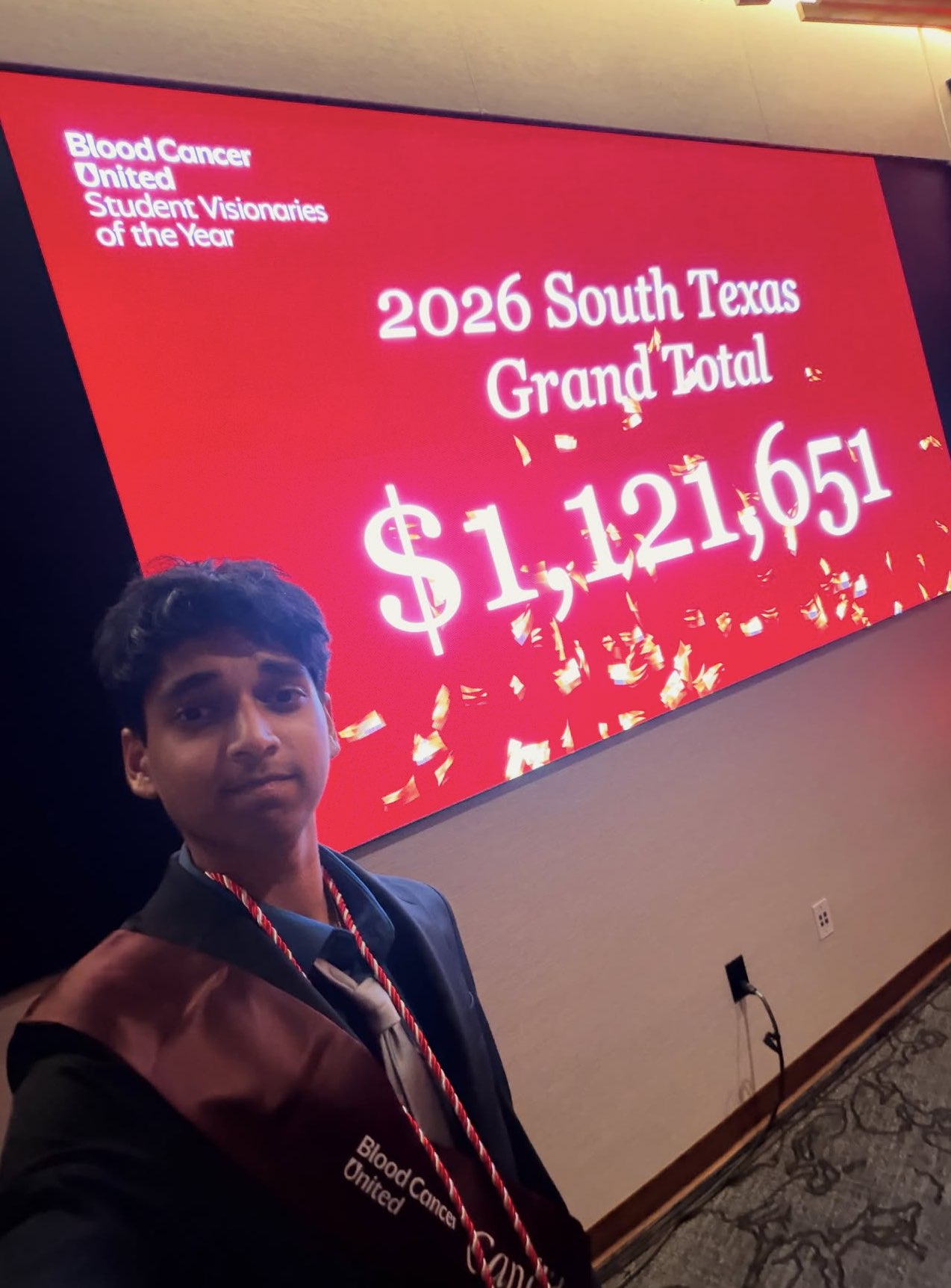 Rehan Raj taking a selfie with the 1.1 million dollar figure raised by South Texas high schoolers against blood cancer